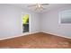 This bedroom features neutral walls, carpet, and natural light offering a blank canvas to personalize at 11828 Mirror Lake Dr, Charlotte, NC 28226