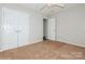 Neutral bedroom featuring carpet, a ceiling fan, a closet and natural light at 11828 Mirror Lake Dr, Charlotte, NC 28226