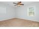 This bedroom features a ceiling fan and two windows, offering a simple and comfortable space at 11828 Mirror Lake Dr, Charlotte, NC 28226