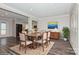 A dining room set is situated on a decorative rug next to the kitchen and a sideboard at 11828 Mirror Lake Dr, Charlotte, NC 28226