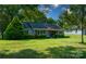 Charming ranch home with gray siding, stone accents, and a well-manicured lawn at 11828 Mirror Lake Dr, Charlotte, NC 28226