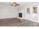 A living area with a decorative fireplace and sliding glass doors to a sunroom at 11828 Mirror Lake Dr, Charlotte, NC 28226