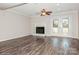 Bright living room featuring a fireplace, ceiling fan and French doors leading to the outside at 11828 Mirror Lake Dr, Charlotte, NC 28226