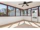 Sun room with screens, door to the outside, and ceiling fan at 11828 Mirror Lake Dr, Charlotte, NC 28226