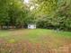 Spacious backyard with shed and wooded area at 1204 Allenbrook Dr, Charlotte, NC 28208