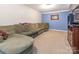 Spacious basement featuring a large sectional couch and carpeted flooring at 1204 Allenbrook Dr, Charlotte, NC 28208