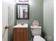 Small bathroom with single vanity and toilet at 1204 Allenbrook Dr, Charlotte, NC 28208