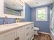 Bright bathroom featuring double sink vanity, white cabinets, and modern fixtures at 1204 Allenbrook Dr, Charlotte, NC 28208