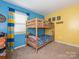 Bright bedroom with a wooden bunk bed and playful decor at 1204 Allenbrook Dr, Charlotte, NC 28208