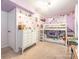 Purple bedroom with bunk bed and dresser at 1204 Allenbrook Dr, Charlotte, NC 28208