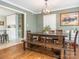 Bright dining room with wood table and bench, hardwood floors, and view of kitchen at 1204 Allenbrook Dr, Charlotte, NC 28208