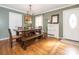 Dining room featuring a wooden table, bench seating, hardwood floors and white accents at 1204 Allenbrook Dr, Charlotte, NC 28208