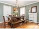 Dining room featuring a wooden table, bench seating, wood floors, and modern lighting at 1204 Allenbrook Dr, Charlotte, NC 28208