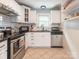 Bright kitchen featuring stainless steel appliances, white cabinets and black countertops at 1204 Allenbrook Dr, Charlotte, NC 28208