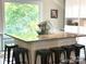 Kitchen island featuring barstool seating, granite counters and white cabinetry at 1204 Allenbrook Dr, Charlotte, NC 28208