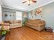 Living room with hardwood floors, two sofas, and a ceiling fan at 1204 Allenbrook Dr, Charlotte, NC 28208