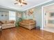 Comfortable living room with hardwood floors, two sofas, and a decorative world map on the wall at 1204 Allenbrook Dr, Charlotte, NC 28208