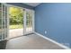 Sun room showcasing access to the backyard through French doors, inviting outdoor view at 1204 Allenbrook Dr, Charlotte, NC 28208