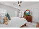 Bedroom with a decorative wooden bed, ceiling fan, carpet, and natural light from shuttered windows at 122 Lanyard Dr # C, Mooresville, NC 28117