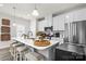 Modern kitchen featuring white cabinetry, stainless steel appliances, and a spacious island at 122 Lanyard Dr # C, Mooresville, NC 28117