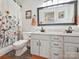 Bathroom with double vanity, shower, and floral-print curtain at 12434 Kemerton Ln, Huntersville, NC 28078