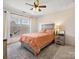 Bright bedroom with a queen bed, window, and ceiling fan at 12434 Kemerton Ln, Huntersville, NC 28078