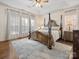 Spacious main bedroom with a large four-poster bed at 12434 Kemerton Ln, Huntersville, NC 28078