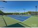 Well-lit tennis courts with green fencing at 12434 Kemerton Ln, Huntersville, NC 28078