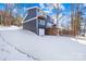 Lakefront home with modern design, deck, and snow-covered yard at 126 Abbey Ln, Mount Gilead, NC 27306