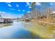 Scenic lake view featuring multiple covered docks and a tranquil reflection of the sky at 126 Abbey Ln, Mount Gilead, NC 27306