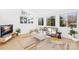 Light-filled living room with gray sofa and large windows at 126 Abbey Ln, Mount Gilead, NC 27306