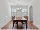 Formal dining room with hardwood floors, wainscoting, and a chandelier at 13303 Hyperion Hills Ln, Charlotte, NC 28278