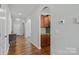 Hardwood floors, an antique console table, and an archway to the kitchen at 13303 Hyperion Hills Ln, Charlotte, NC 28278