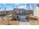 Two-story house with gray siding, brick accents, and a two-car garage at 13303 Hyperion Hills Ln, Charlotte, NC 28278