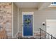 Blue front door with a rustic-style fall wreath at 13303 Hyperion Hills Ln, Charlotte, NC 28278