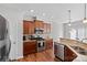 Bright kitchen with stainless steel appliances and wood cabinets at 13303 Hyperion Hills Ln, Charlotte, NC 28278