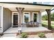 Inviting front porch with stone accents, wooden columns, and a cozy bench for relaxing at 136 Longwood Rd # 47, Mooresville, NC 28115