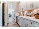 Walk-in pantry features white cabinets, quartz countertops, and a wine refrigerator at 136 Longwood Rd # 47, Mooresville, NC 28115