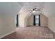 Large bedroom with vaulted ceiling, window with blue curtains, and carpet floor at 138 Augusta Ln, Shelby, NC 28150