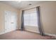 Simple bedroom with carpet, window with blinds and grey curtains at 138 Augusta Ln, Shelby, NC 28150