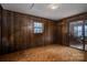 Simple bedroom with wood paneling and carpeting at 1408 Gaither Rd, Belmont, NC 28012