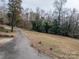 Long driveway leading to a house with wooded surroundings at 1408 Gaither Rd, Belmont, NC 28012