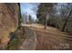 Landscaped side yard with walkway leading to a tranquil setting at 1408 Gaither Rd, Belmont, NC 28012