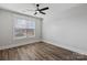 Bright bedroom featuring hardwood floors, a ceiling fan and a large window at 1846 Yardley St, Rock Hill, SC 29732