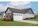 Spacious two-car garage with white door, stone accents, and well-maintained landscaping at 1846 Yardley St, Rock Hill, SC 29732