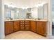 Double vanity bathroom with dark brown cabinets and beige tile floors at 2008 Fallondale Rd, Waxhaw, NC 28173