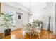 Formal dining room with hardwood floors, white wainscoting, and a charming table setting at 2008 Fallondale Rd, Waxhaw, NC 28173