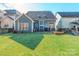 Blue house exterior with a well-maintained lawn and backyard patio at 2008 Fallondale Rd, Waxhaw, NC 28173