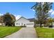 Single car garage with driveway and grassy yard at 214 Heather Glen Ln, Belmont, NC 28012