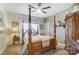 Charming bedroom with a four-poster bed, neutral color palette, and built-in shelving at 217 Ridge Reserve Dr, Lake Wylie, SC 29710